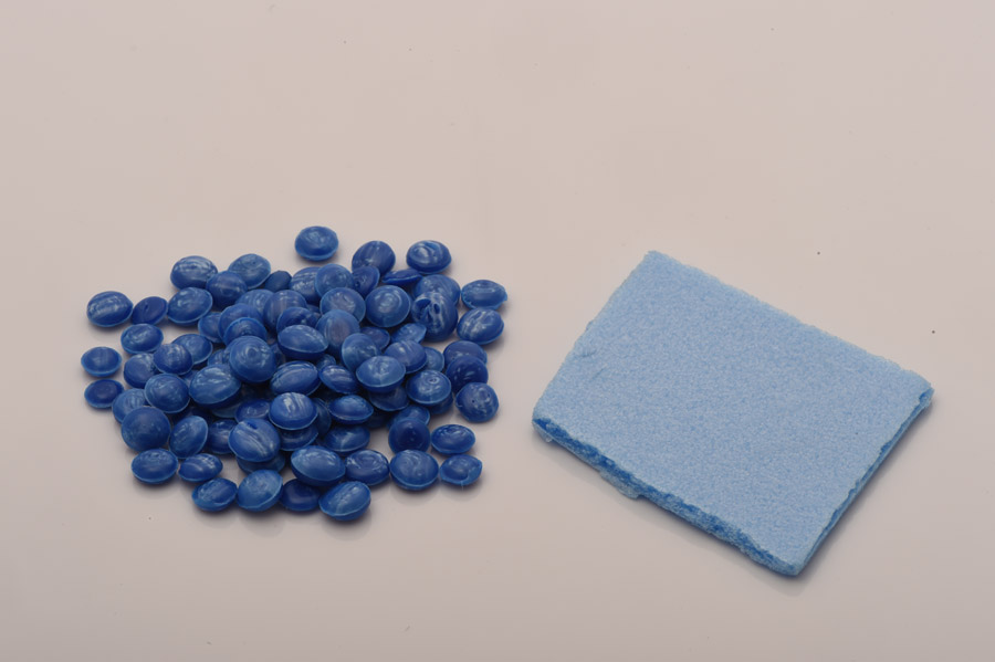 Blue plastic pellets and a light blue foam sample displayed on a white background.
