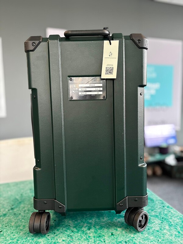 A black suitcase made from recycled plastics.